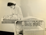 Nurse Examining Infant at Conley Maternity Hospital by Kansas City College of Osteopathy and Surgery